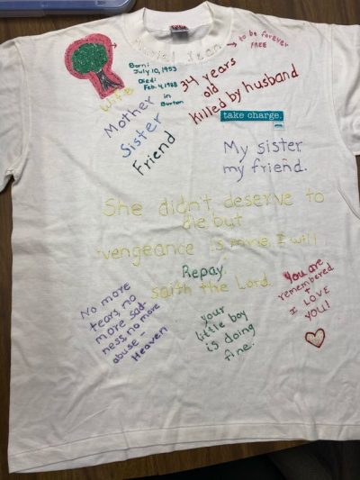 "She didn't deserve to die, but 'Vengeance is mine, I will repay saith the Lord.'" "Mother, wife, sister, friend." "Born July 10th, 1953. Died February 4th, 1988 in Burton." "34 years old, killed by husband." "My sister, my friend." "No more tears, no more sadness, no more abuse- Heaven." "Your little boy is doing fine." "You are remembered and I love you." "To be forever free." White represents people who have died due to violence.