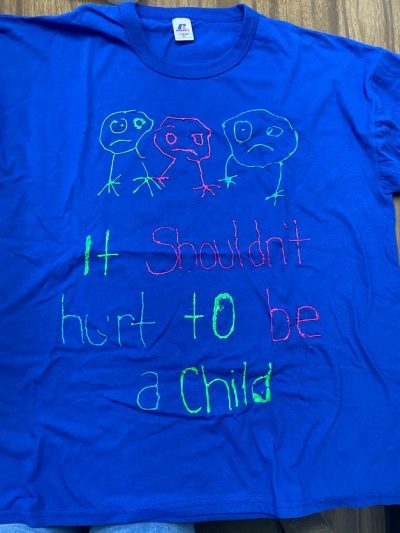 "It shouldn't hurt to be a child." Blue represents survivors of incest or child sexual violence.