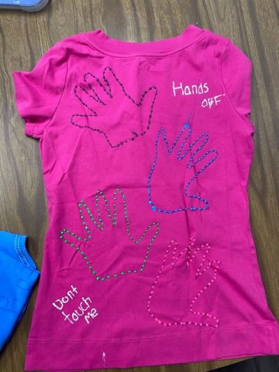 "Hands off." "Don't touch me." Pink represents survivors of rape and sexual assault.