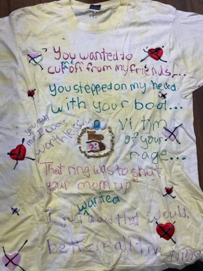 “You wanted to cut me off from my friends. You stepped on my head with your boot…” “You told me I was worthless.” “Victim of your rage.” “That ring was to shut your mom up.” “I just wanted a dad that would be there all the time.” White represents victims who have died of violence.
